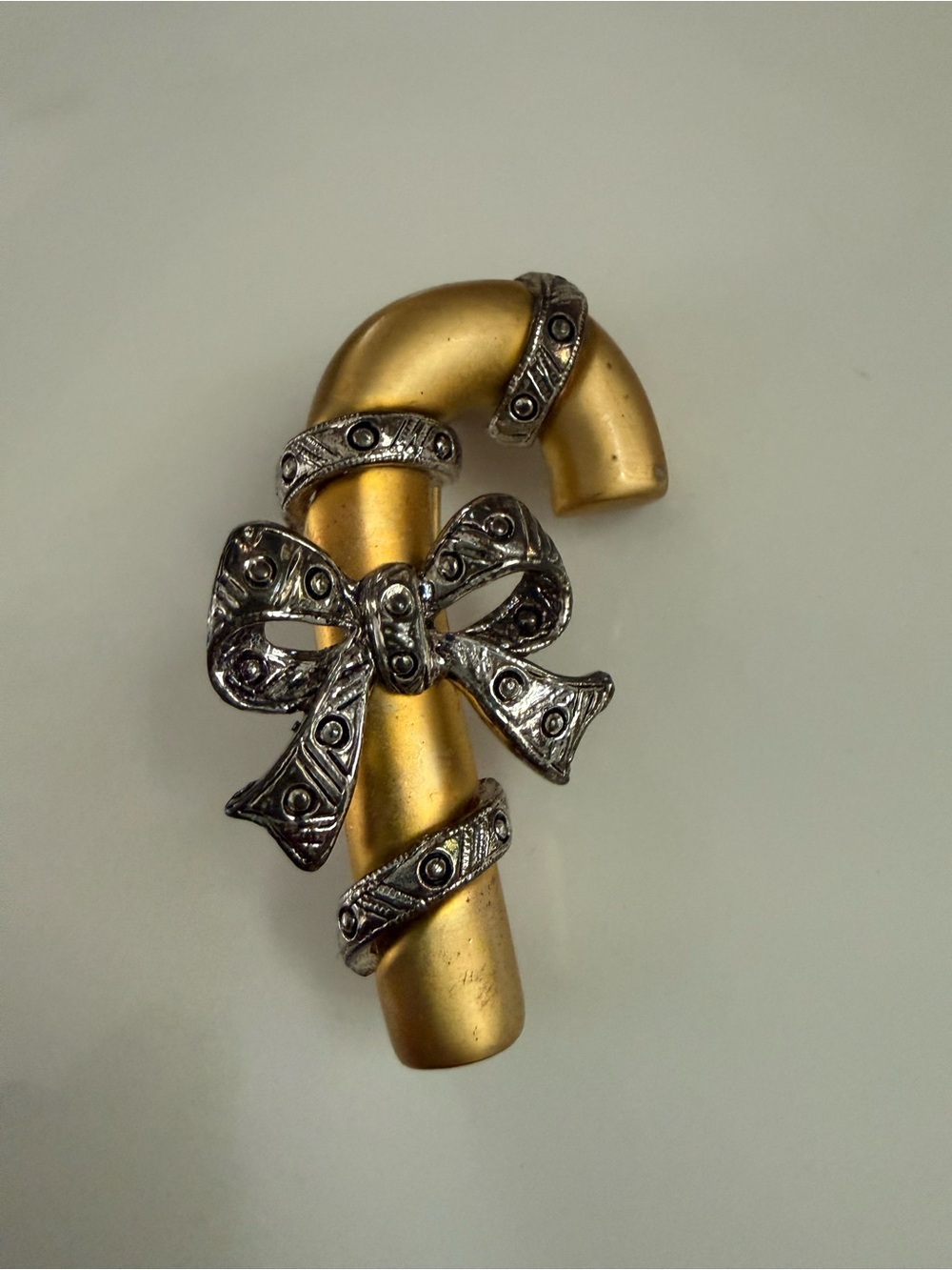 Gold-tone Candy Cane Brooch with Pewter Bow Accent